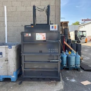 Presse à balles Clean Kompact 151 d'IDS Environnement installée à l'extérieur du magasin Mr.Bricolage de Craponne, prête à compacter les déchets carton du magasin.